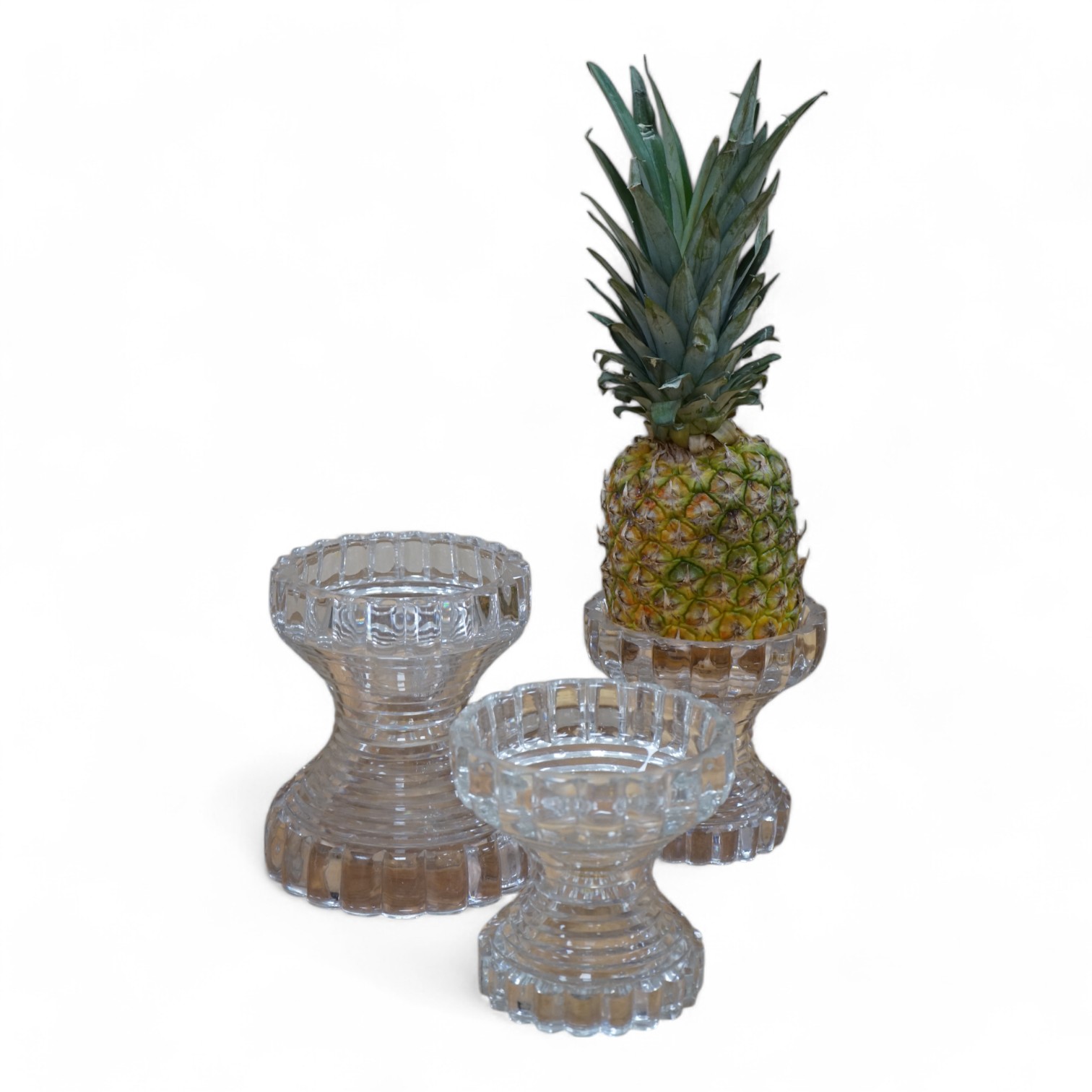 A set of three Regency cut glass pineapple stands, 19cm. Condition - several chips